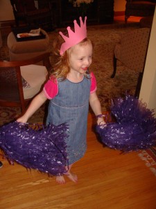 Annie gets her cheer on with her new pom-poms Sylvia and I found at a discount warehouse. (Where perhaps some scrapbooking supplies were also purchased.)